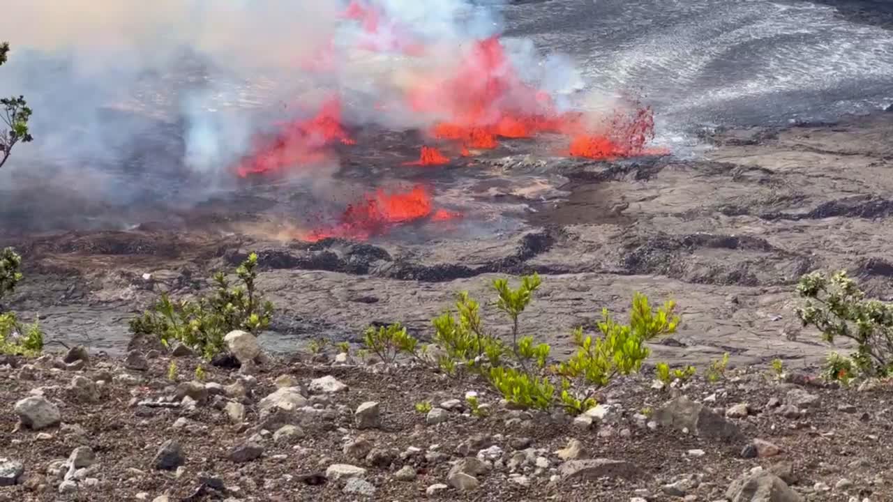 Cinematic long lens booming up shot of lava fountains spewing out of Kilauea Crater mere minutes after eruption began in September 2023 at Hawai'i Volcanoes National Park