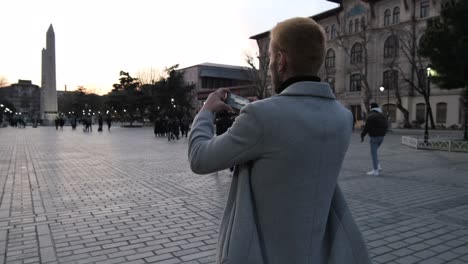 tourist taking a photo of the obelisk