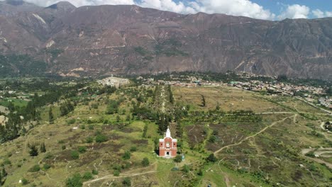 wide aerial view of the church at yungay cemetery, áncash, peru, with the majestic andes in the background. a historic site honoring the victims of the 1970 earthquake
