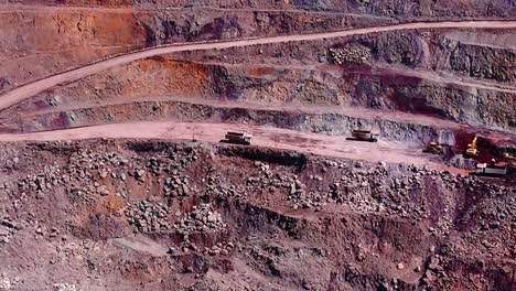 panning drone shot of dirt roads and machines at siana glod and silver mine, mainit, philippines