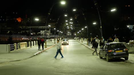 Traffic and people on the Bab El Kantara bridge at night