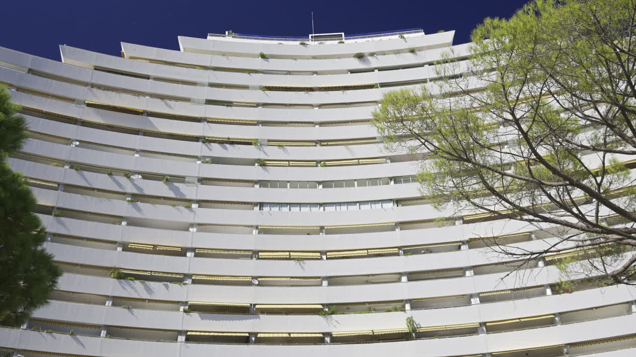 Close up of the white, large, pyramid-shaped building in the Marina Baie des Anges complex in Villeneuve-Loubet, France