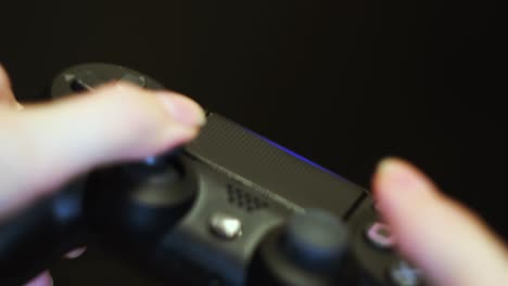 hands holding a black video game controller