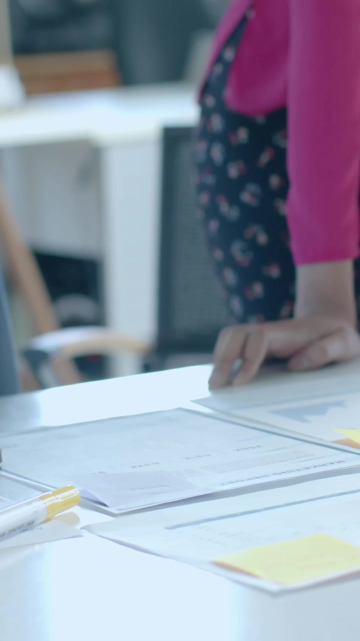 Animation of data processing and diagrams over diverse colleagues with blueprints in office