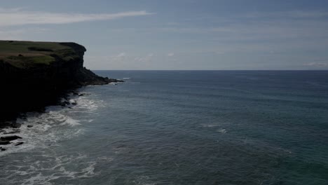 stunning aerial view of el bolao cliff with the serene ocean below in cobreces, spain