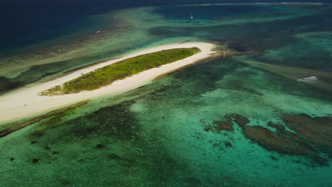 A-small-island,-part-of-the-archipelago-of-the-Isle-of-Pines-in-New-Caledonia---aerial-parallax-view