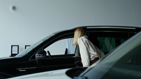 woman looking at cars in a showroom