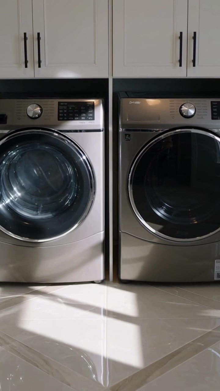 Vertical video: Shifting sunlight showing front-load machines in laundry room, left drum showing