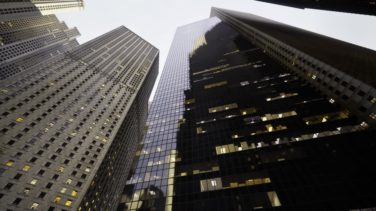 Skyscrapers create dramatic shadows in urban cityscape at dusk