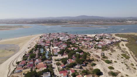 Armona-island,-Olhao-Portugal,-showing-houses,-beach,-and-surrounding-waters,-aerial-view