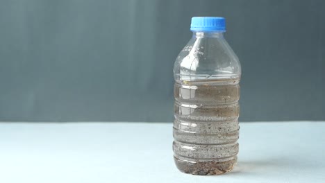 agua sucia en una botella de plástico