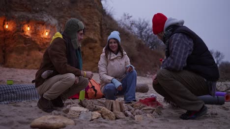 friends enjoying a cozy evening by the campfire on the beach