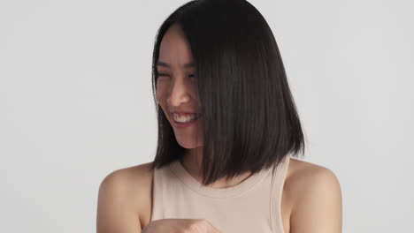 카메라 앞에서 부끄러워하는 아시아 여성.