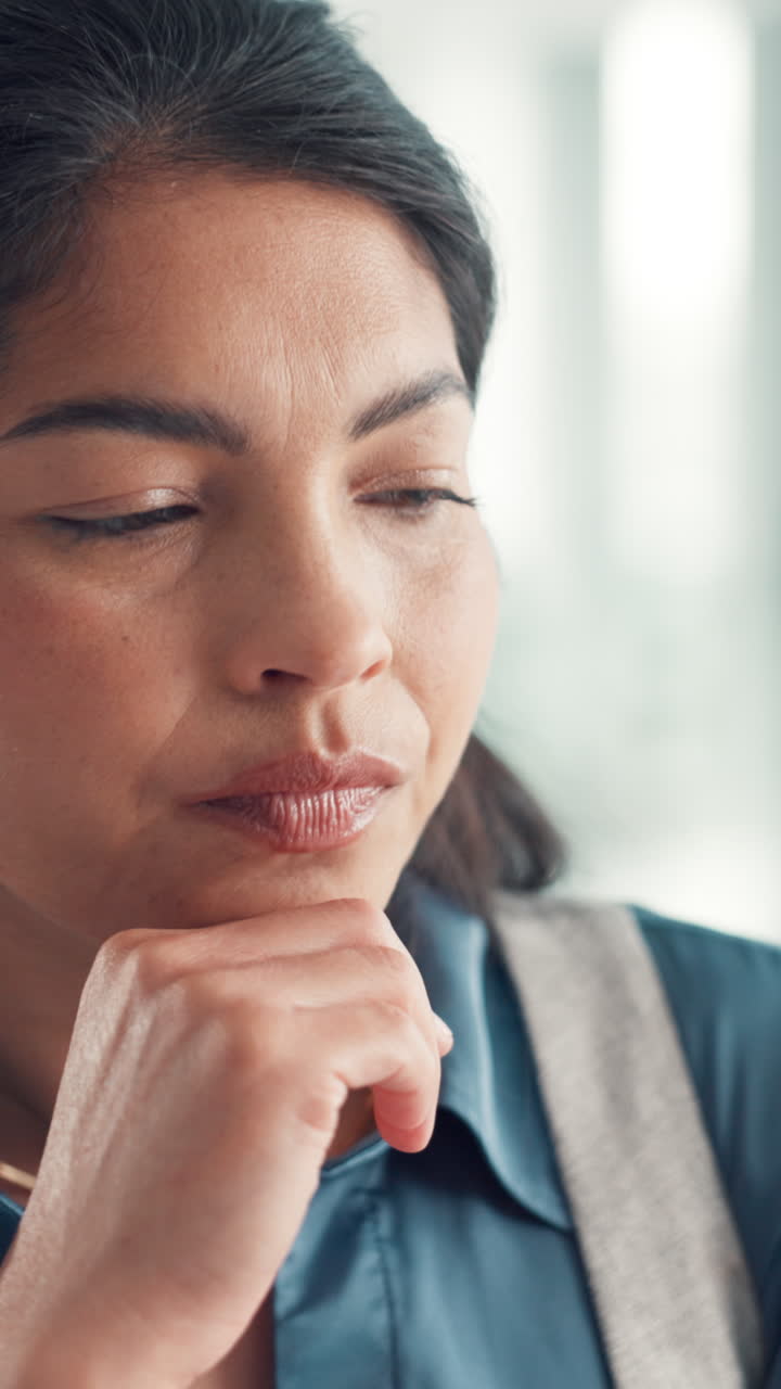 Close-up of Thoughtful Woman Resting Chin on Hand