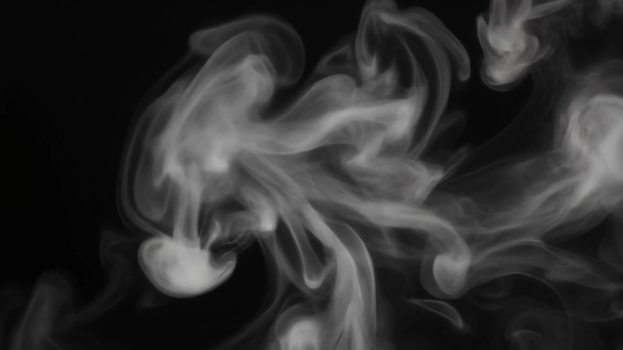 White Smoke Swirling Against a Black Background