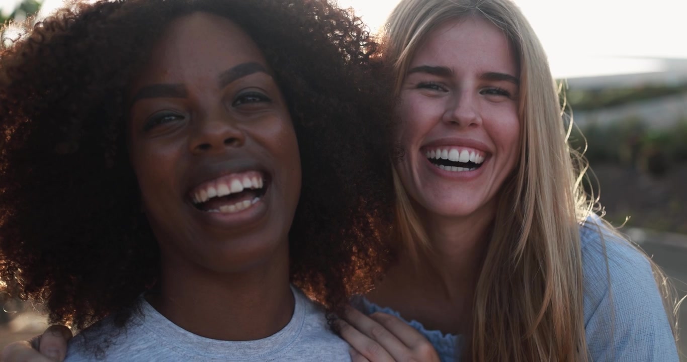 Happy Multiethnic Female Friends Laughing at Camera