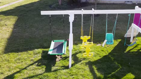 aerial view of a swing set in the back yard on a bright sunny day