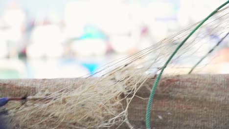 Slow-motion-shot-of-old-fishing-nets-being-pulled-from-the-ocean-with-no-fish-caught