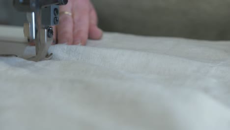 fabric being fed through sewing machine 4k