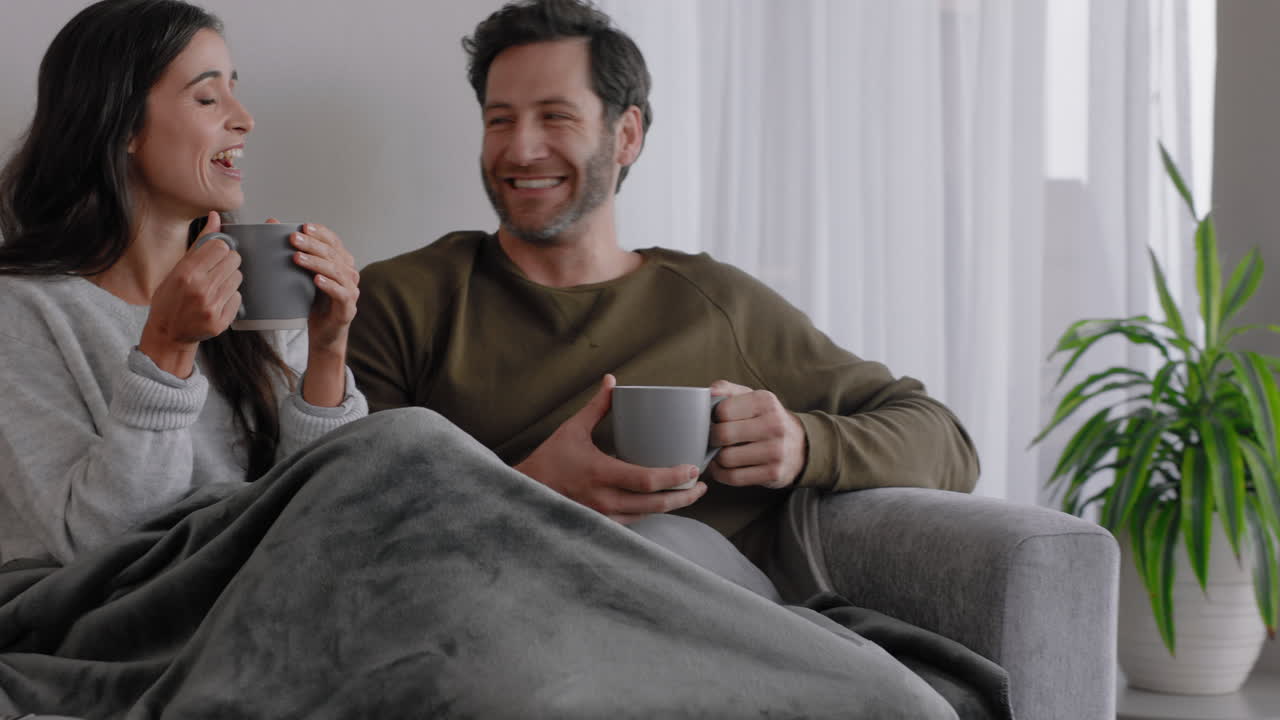 group of friends drinking coffee together relaxing at home chatting having conversation enjoying weekend