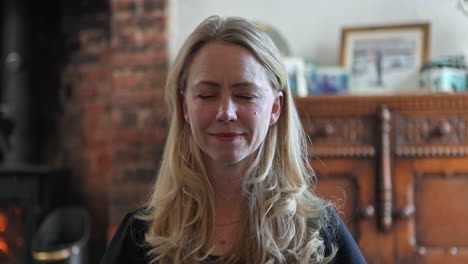 woman in prayer with a smile