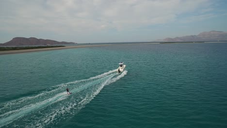 Aerial-shot-of-a-person-skiing-in-a-Island-in-the-Sea-of-Cortez