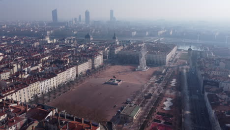 aerial panning shot of bellecour square in lyon french city with scenic morning sunlight