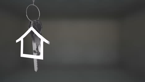 animating house-shaped keychain over blurred background