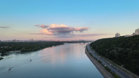Aerial-view-of-the-Dnipro-river-in-Kiev-with-a-highway-on-the-low-right-with-dense-traffic