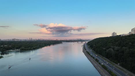 aerial view of the dnipro river in kiev with a highway on the low right with dense traffic