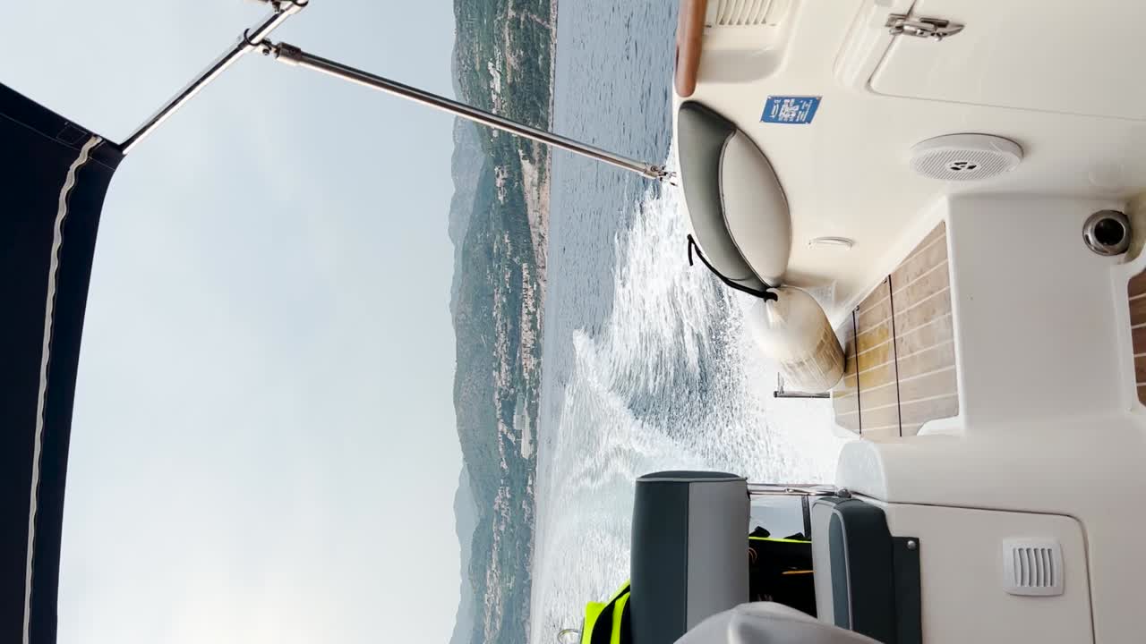 View from the stern of the boat going fast while leaving a trail of foam behind it, Croatia