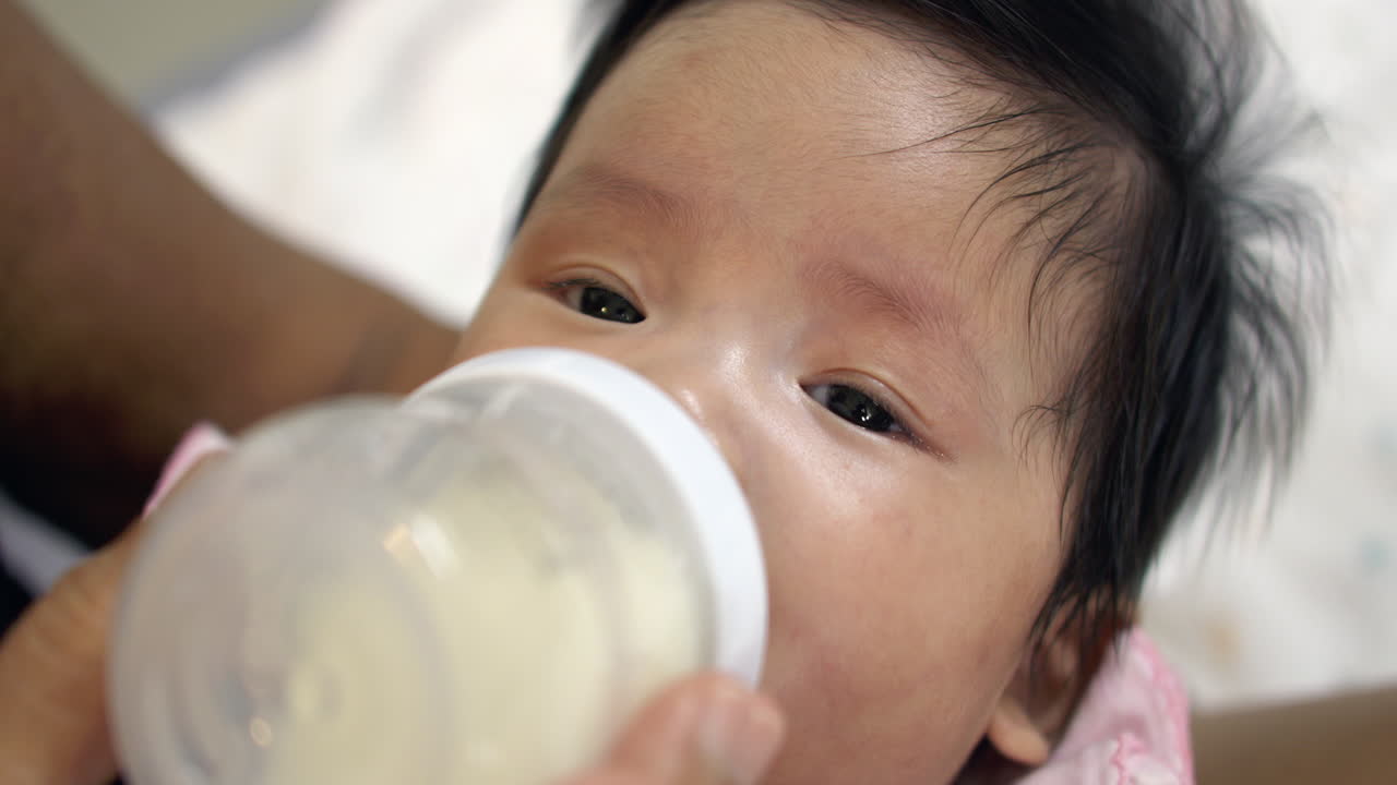Adorable Baby Girl Bottle Feeding