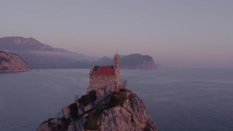 orbit shot around nedjelja church at montenegro during magical golden light, aerial