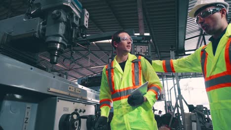 Factory-worker-warn-coworker-about-safety-and-give-hardhat-to-him