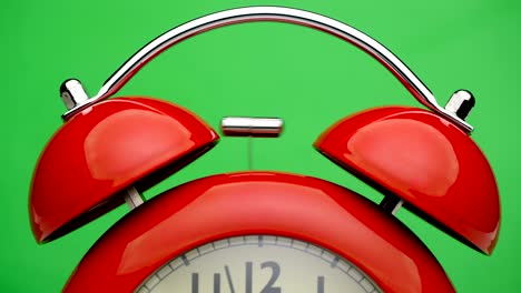 red alarm clock. green screen. close up view.