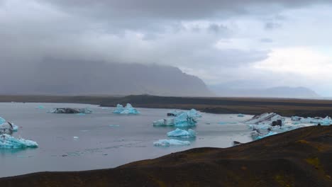 Traveling-drone-of-Diamond-Beach:-the-beach-with-ice-blocks-in-the-south-of-Iceland