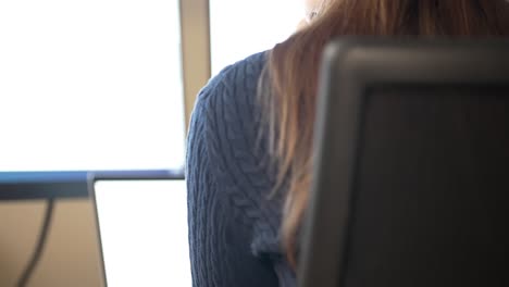 businesswoman working on a computer in a minimalist workspace