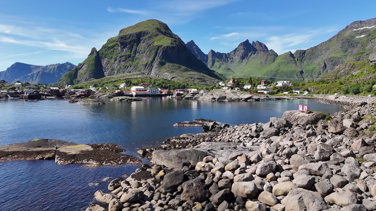 Aerial footage of the fishing village Å, nestled between steep mountains with scenic coastlines in the Lofoten Islands, Norway