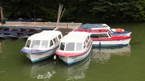 three boats docked at a pier