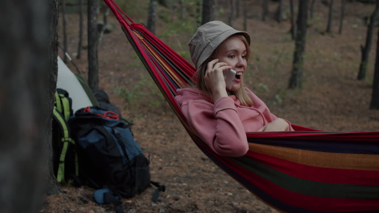 Woman relaxing in a hammock in the forest