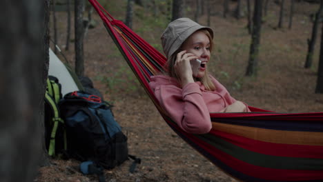 woman relaxing in a hammock in the forest