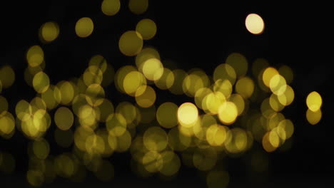 múltiples luces de hadas amarillas brillando sobre un fondo negro