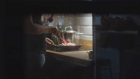 woman cooking seafood dish for family dinner