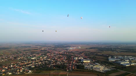 hot air balloons over a picturesque village