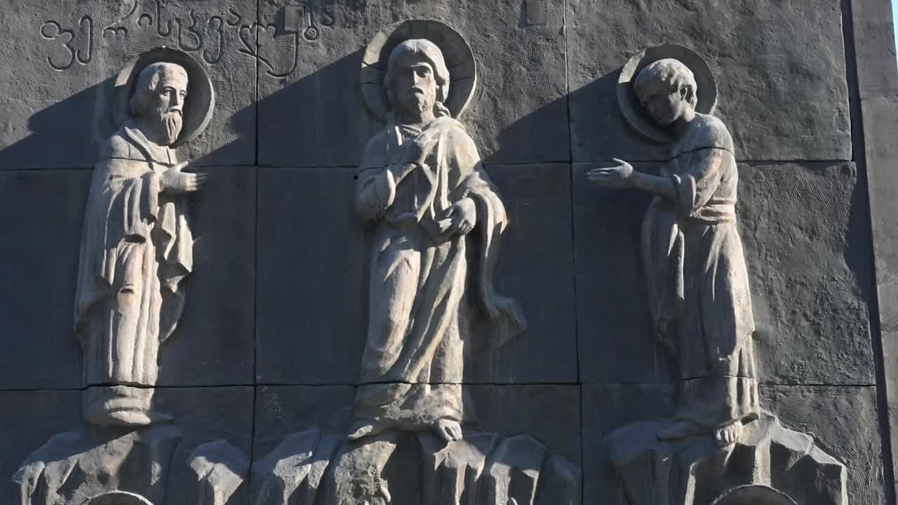 Intricate stone pillars and reliefs at the Chronicle of Georgia monument reveal detailed artwork celebrating Georgian history, faith and cultural identity