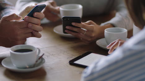 business people hands using smartphone browsing working online collaborating on mobile technology networking together friends relaxing in cafe drinking coffee enjoying leisure lifestyle close up