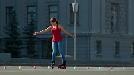 girl teenager trains on roller skates, goes around the cones on the site. slalom on roller skates, criss cross. 4k, 10bit, prores