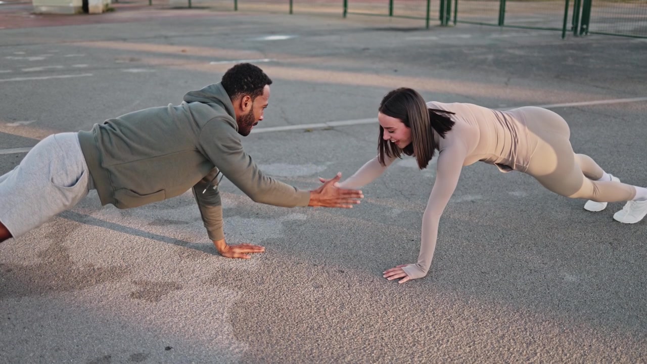 Couple Doing Push-Ups and High-Fiving Outdoors