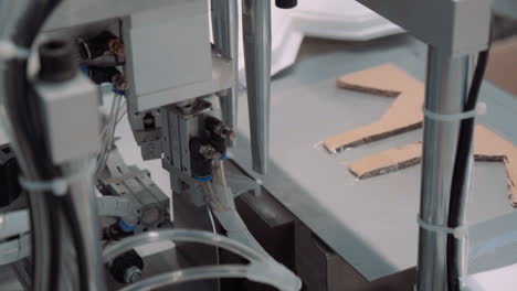 gluing the elastics to face masks, workers perform the operation with an automatic machine