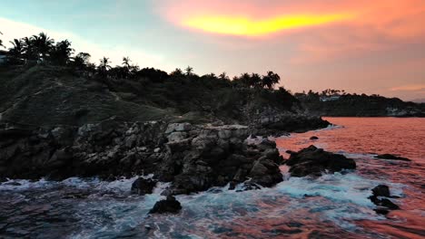 tropical pink sunrise aerial drone fly over cliff puerto escondido jungle ocean